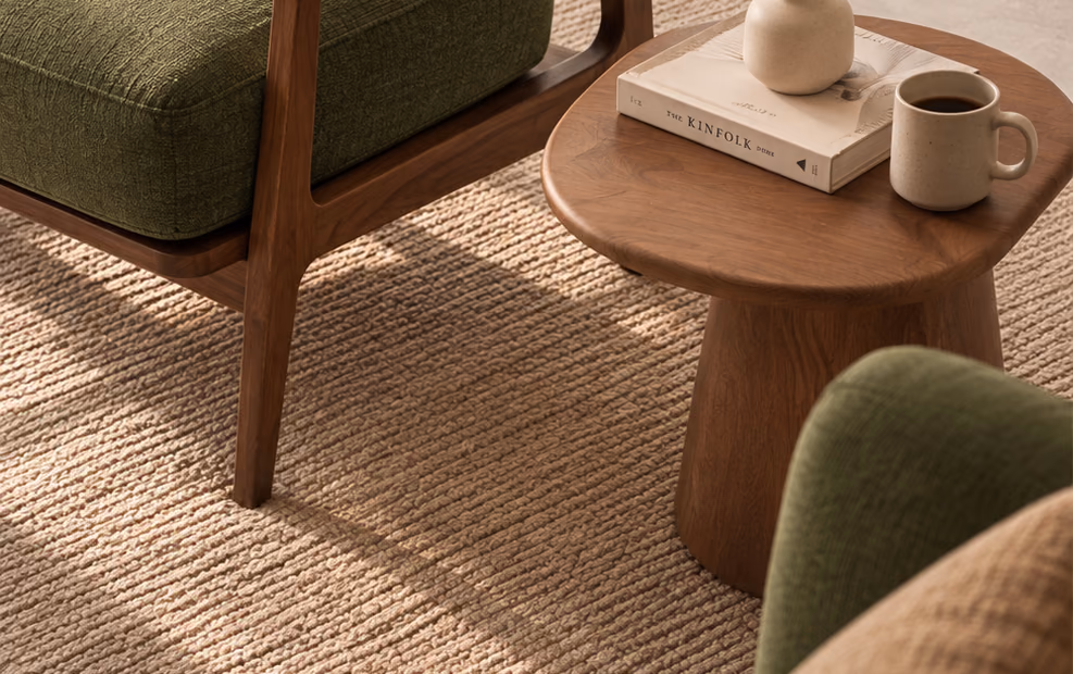 Arlo Lounge Chair cushion next to a wooden side table with a coffee mug